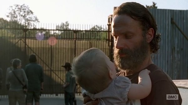 rick with baby outside alexandria community walking dead ep 11