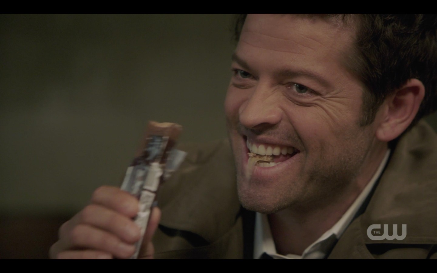castiel laughing eating candy bar spn 1408
