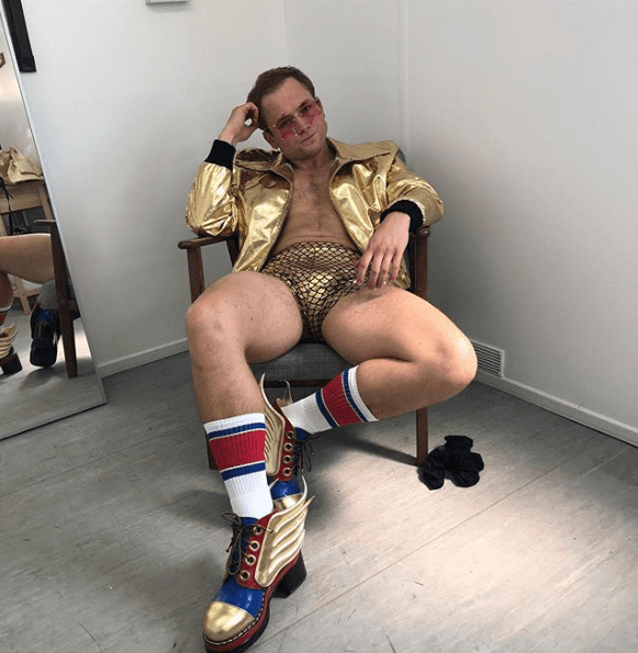 Taron Egerton is tight gold lame bulge reveal shorts for Rocketman Elton John.