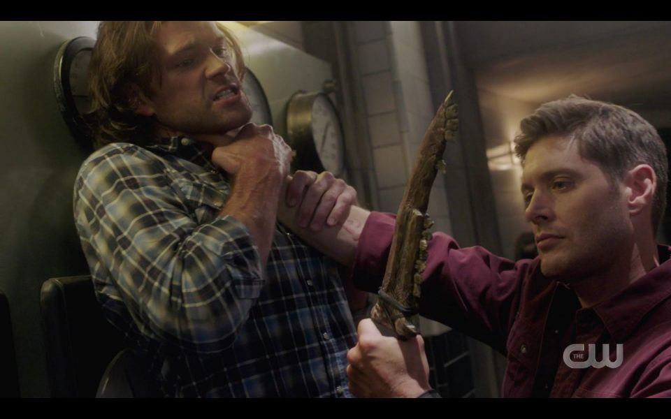 Evil Dean looking at big knife while holding Sam up by throat 1505 SPN