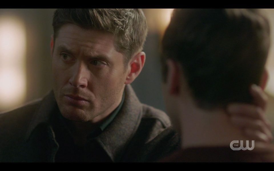 Dean Winchester glancing at Castiel while holding Jacks head 1511