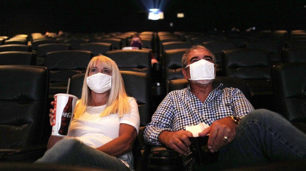 moviegoers wearing maskes at tenet screening 2020