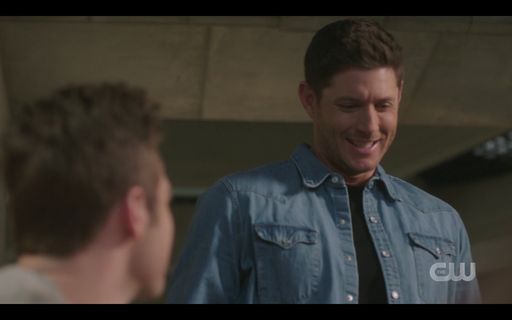 Dean Winchester smiling wide for Jack birthday cake.