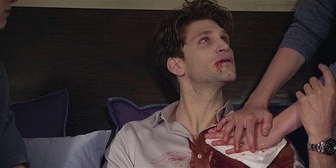 Walker August holding down on Liams bleeding wound with STella.