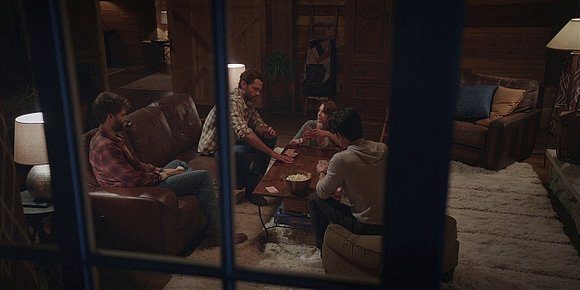 Walker family with Jared Padalecki sitting in family room playing games and talking.
