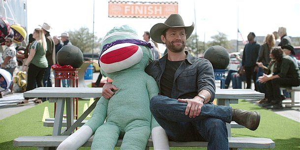 Jared Padalecki sitting with life sized monkey on bench saying classic Friends Joey line how you doin