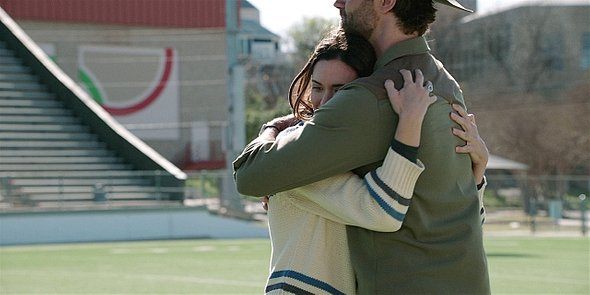 Cordell and Geri hugging tight on football field Walker 216.