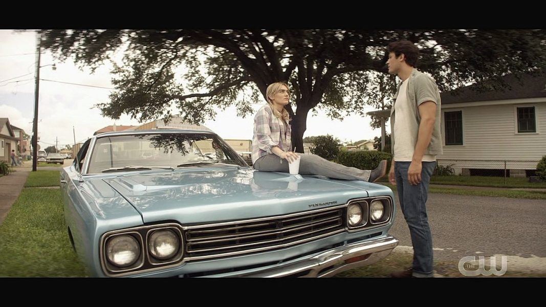 Mary Winchester sitting on Impala car with John.