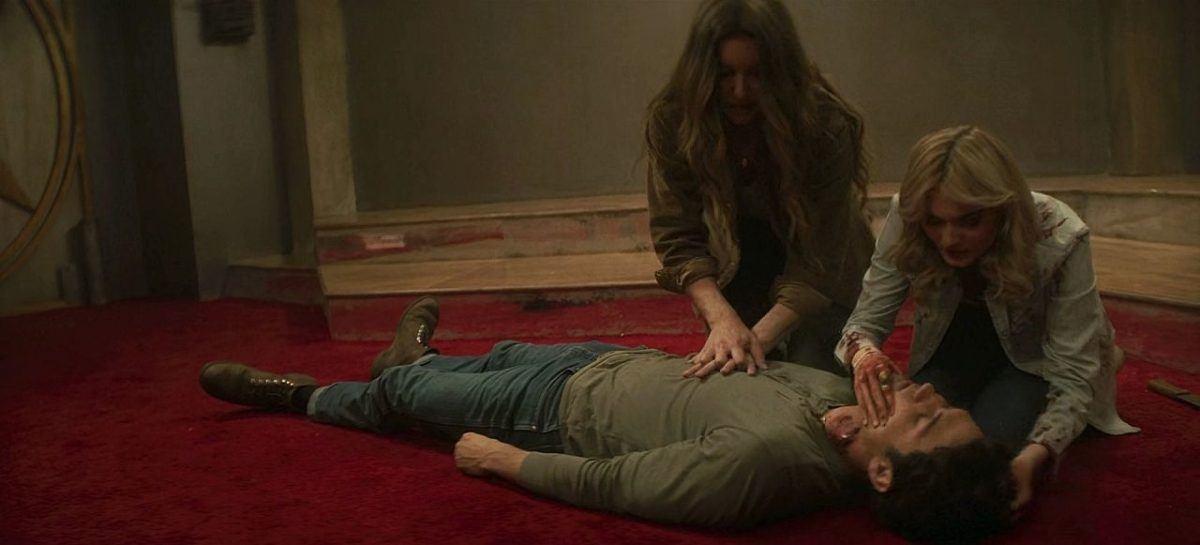 John Winchester out cold as Millie and Mary try to revive him by touching his body 1.09.