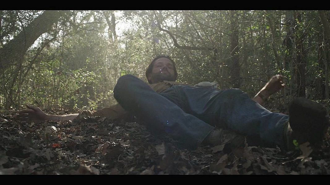 Jared Padalecki laying on ground in Meat Rack on Fire Island waiting for a hook.