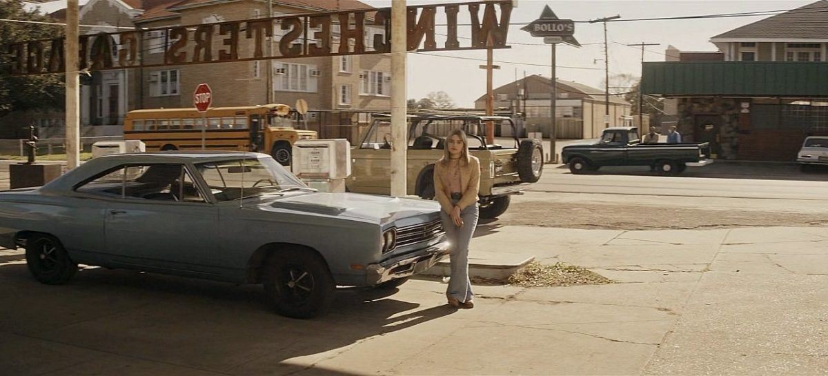 Mary Winchester in 1970s clothes with Baby at gas Station.