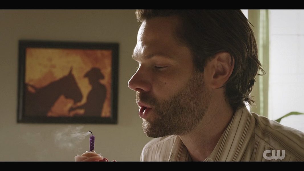 Jared Padalecki gently blowing off a candle for Mitch Pilleggi on Walker set.