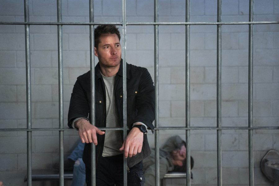 Justin Hartley in jail mug shot for pandering with hot cops in bathrooms on Trackers set.