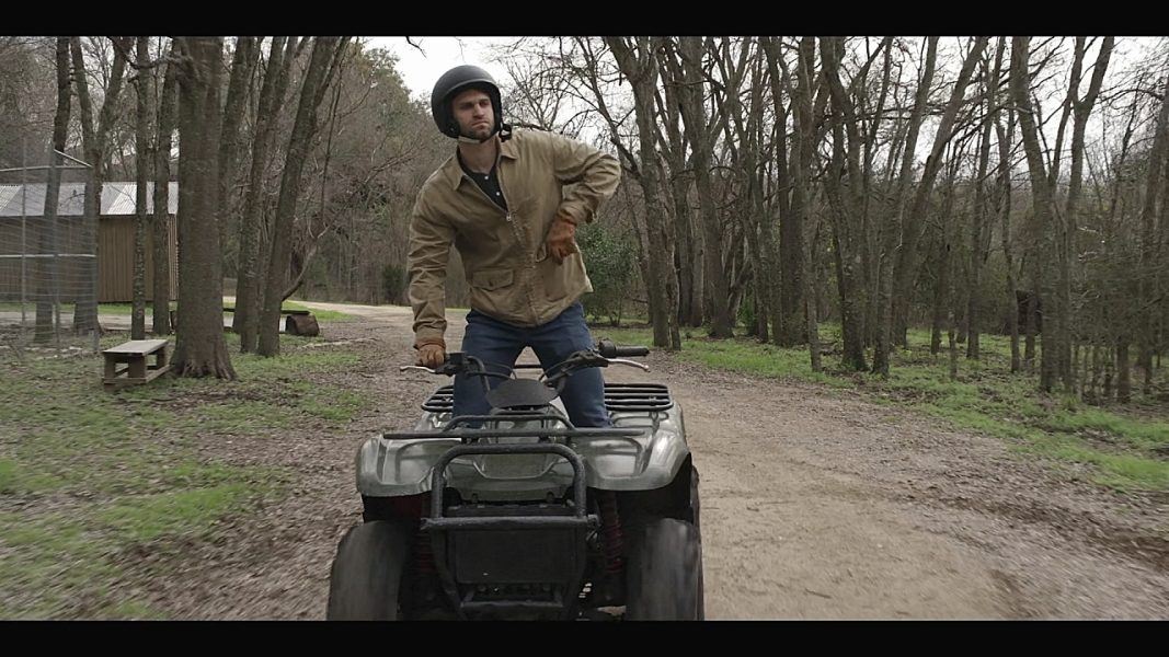 Walker gay Liam riding hard on an ATV on dirt road.