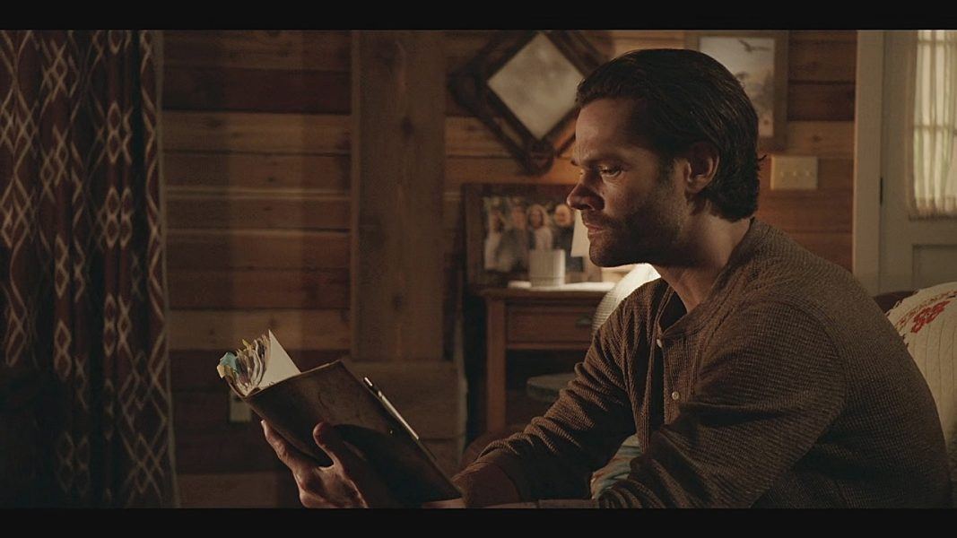 Jared Padalecki reading Supernatural style  journal on Walker set.